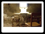 subroom : icarus after the fall : chair - brick table - electronic reading magnifier